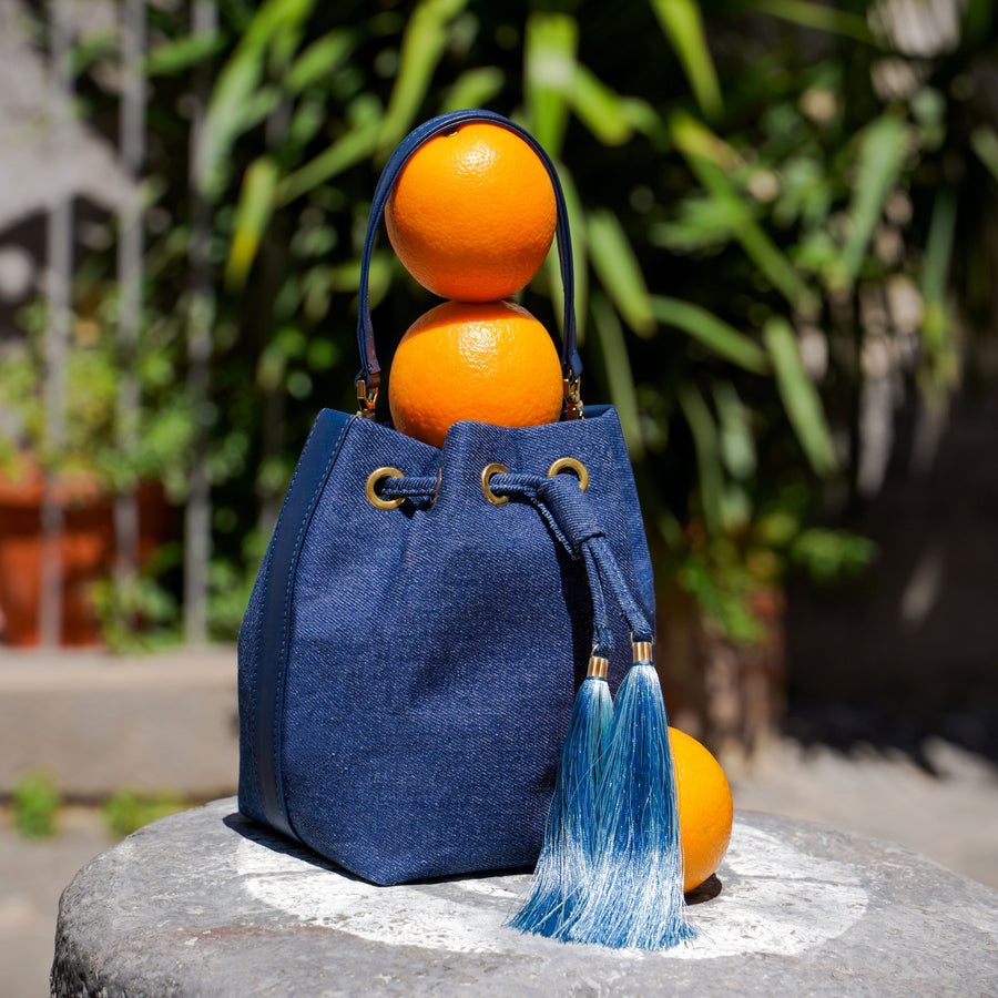 Mikó Bucket Bag in Denim and Leather filled with oranges